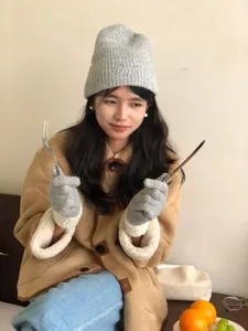 Cozy winter knitted wool gloves and beanie set, warm and thick for cold weather cycling.