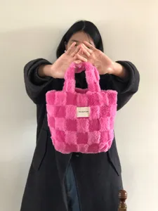 Pink plush checkered handbag, soft fuzzy winter tote bag with stylish pattern for daily use.