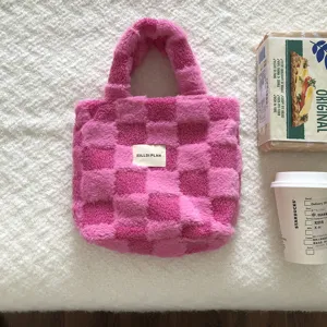 Detailed close-up view of the pink plush checkered handbag, soft fuzzy winter tote bag texture.