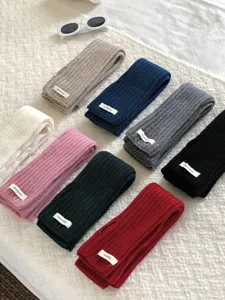 Detailed view of ribbed knit wool arm warmers in multi-color solid designs, soft texture.