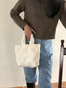 Plush checkered handbag detail, soft fuzzy fabric material, cozy winter bag showcase.