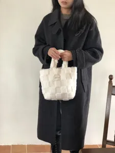 Pluffy checkerboard handbag for women, stylish winter plush tote bag with double handles.