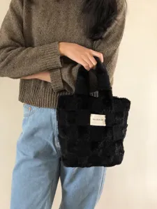Black plush checkerboard detail shot of women winter fluffy handbag, soft texture design.
