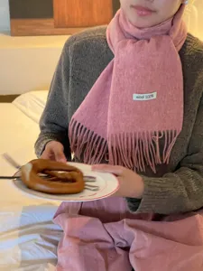 Cozy pink winter wool scarf for women, featuring a soft fringe design and 100% wool.