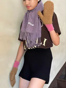 Detailed view of winter wool fringe scarf and knitted mittens set in stylish daily wear.