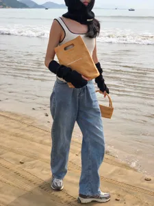 Cozy long black knitted arm warmers outdoor beach scene detail stylish winter accessory