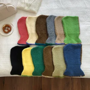 Detailed view of winter knitted balaclava hooded scarf in multiple colors with contrast trim design.