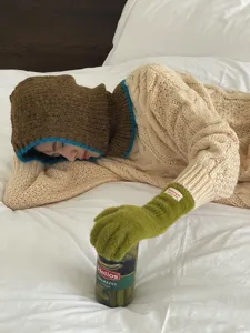 Winter knitted balaclava hat with cozy gloves, stylish winter warm headwear detail view.