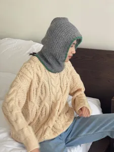 Cozy winter knit balaclava hat and scarf all-in-one, stylish warm headwear for cold days.