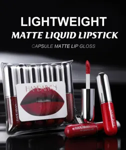 Close-up of capsule matte liquid lipstick set in transparent bag with bright red shade.