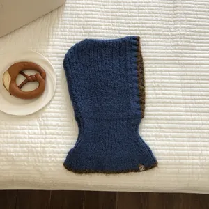 Chic blue knit balaclava with brown trim, stylish winter warm hooded scarf detail view.