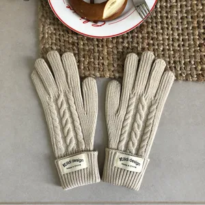 Detailed close-up of beige cable knit winter gloves, warm wool texture for cold days.
