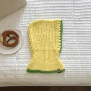 Detailed view of the yellow and green knitted balaclava hood, showing cozy winter texture.