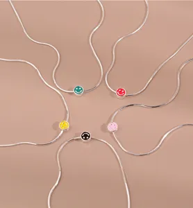 Chic stainless steel snake chain necklace with colorful enamel smiley face pendants for women.