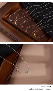 Silver snake chain necklace featuring colorful enamel smiley face charms for women, chic and trendy.
