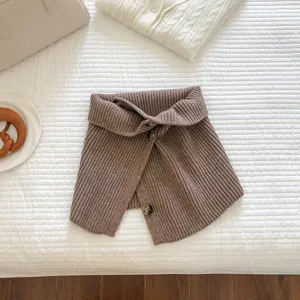 Brown knitted button collar close-up, soft textured winter neck warmer accessory detail shot.