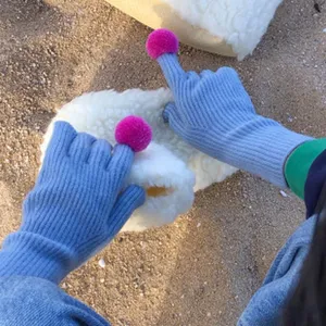 Women winter long knit gloves with cute pink pom-poms, touch screen wool blend gloves for cold days.