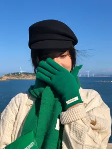 Green wool knit gloves and scarf set, perfect warm winter fashion accessory detail view.