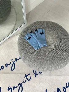Gemütliche helle blaue Strickhandschuhe mit süßen schwarzen Schleifen für kalte Wintertage.