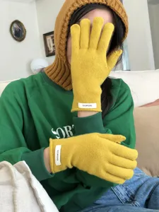 Winter warm yellow knit gloves detail shot, soft wool material, stylish daily wear.