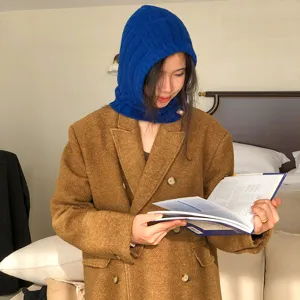 Detailed close-up view of the warm blue knitted balaclava and cozy winter coat styling.