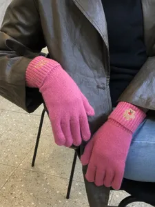 Cozy pink knit touchscreen gloves featuring cute bear embroidery for winter warmth.
