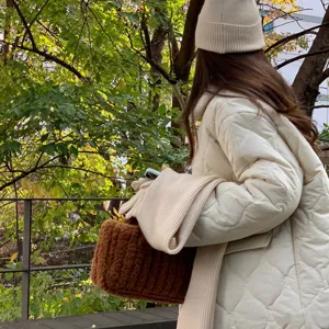 Détail de bonnet en tricot chaud d'hiver et sac en peluche, style de tenue confortable.