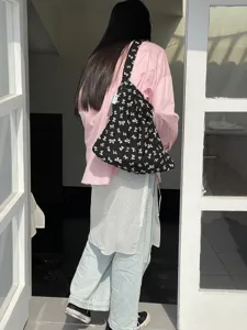 Black canvas shoulder bag with cute white bow print, casual lazy style student shopping bag.