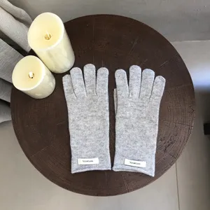 Detailed view of cozy light gray 100% wool knit winter gloves, warm and soft for daily wear.