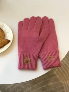 Women pink knit gloves winter warm five-finger gloves with cute bear embroidery and text.