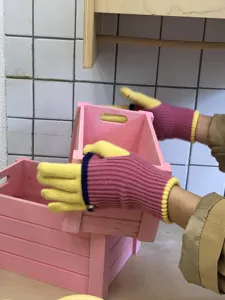 Detail view of women's color-block knit gloves showing textured cuffs and warm fleece lining.