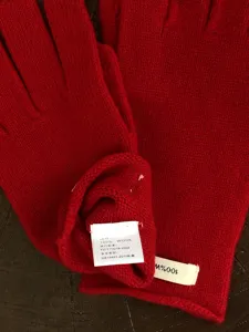 Winter warm solid color 100% wool knit gloves detail shot showing material tag and soft texture.