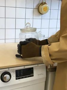 Detailed view of women's double-layer knit color-block gloves with long ribbed cuffs.