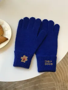 Blue knit touch screen gloves detail with cute bear embroidery and stylish letter design.