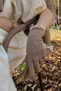 Women winter knit touchscreen gloves detail, stylish warm wool yarn outdoor cold weather wear.