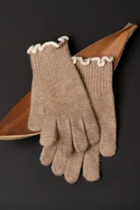 Detailed close-up of cozy knit touchscreen gloves with elegant ruffled white cuffs in camel.