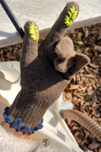 Women's brown knit touch screen gloves with fluorescent green fingertip openings and blue cuffs.