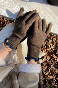Women's brown knit touch screen gloves with blue ruffle cuffs, warm winter wool winter wear.