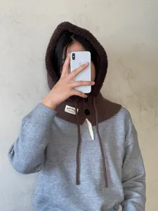 Knitted balaclava hood and scarf two-in-one winter warm wool hat paired with grey sweater outfit