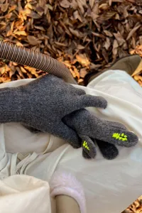 Women's dark grey knitted touchscreen gloves with cute yellow fingertip embroidery details.