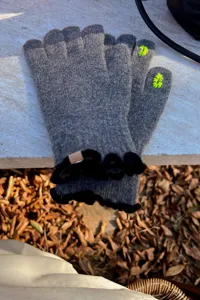 Grey knit touch screen gloves detail, winter warm wool blend gloves with black ruffles.