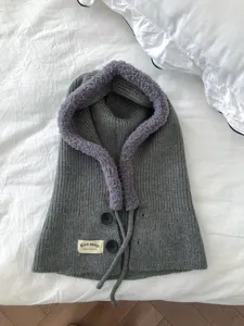 Detail view of the winter knitted balaclava hood scarf combo with warm faux fur trim and buttons.