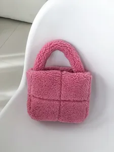 Close-up of pink fluffy teddy plush handbag detail, cute padded winter style tote bag.
