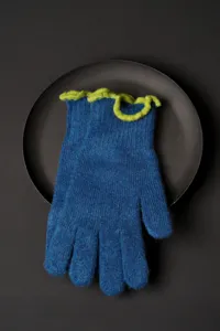 Detailed shot of winter warm knit touch screen gloves for women with blue and green frilly cuffs.