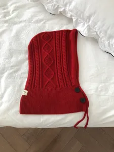 Red knit balaclava hooded scarf with cable pattern, buttons and drawstring for women detail.