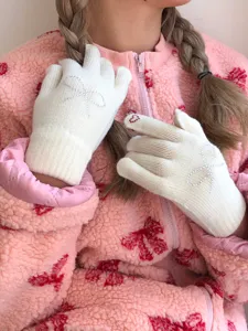 Chic winter knit gloves featuring sparkling rhinestone bows for women, warm and stylish daily wear detail.