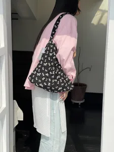 Black bow print canvas shoulder bag, casual style student tote bag, trendy detail view.