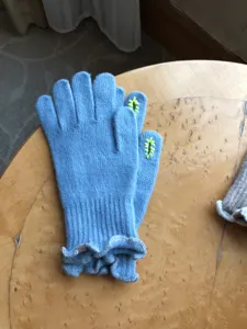 Women's blue touchscreen knit gloves detail view, stylish warm wool winter gloves for ladies.