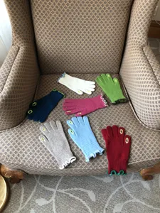 Detail shot of women's touchscreen knitted wool gloves in various colors for winter warmth.