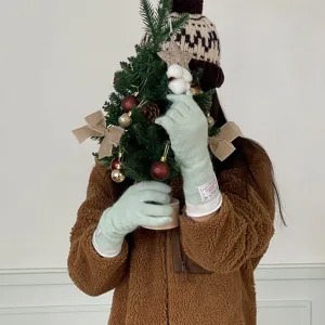 Women's winter warm knit long gloves in candy light green color, cozy apparel.